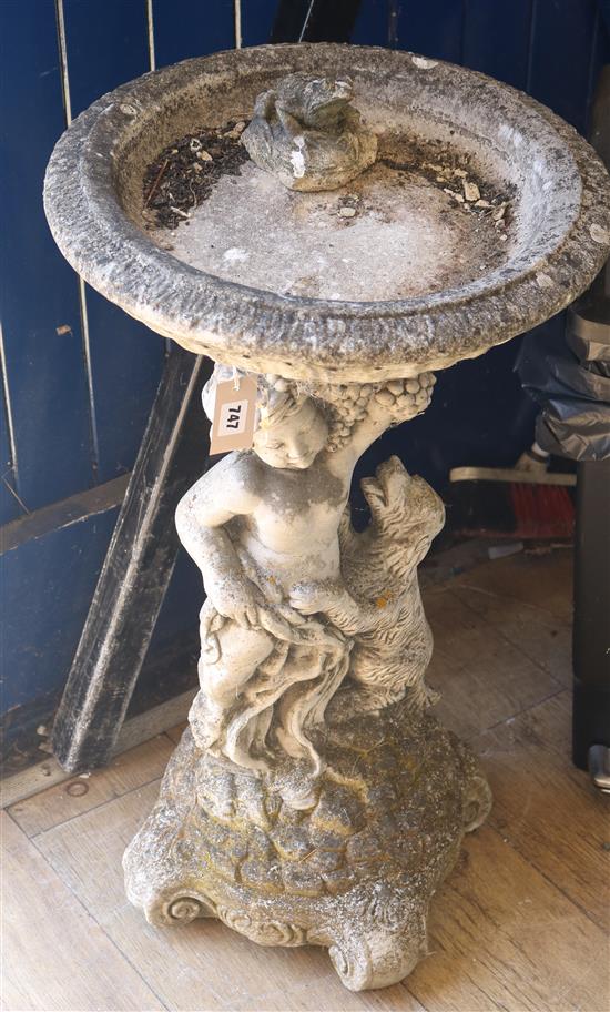 A reconstituted stone cherub bird bath W.42cm